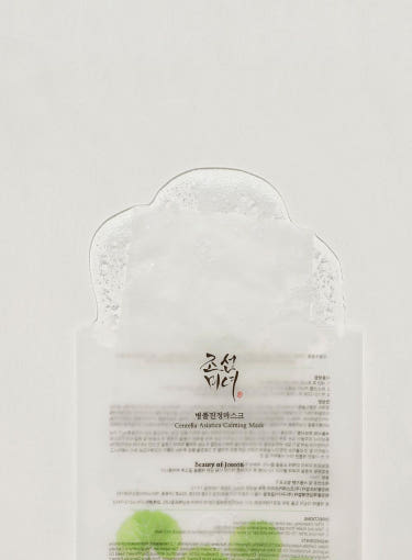 Beauty of Joseon Centella Asiatica Calming Mask packet with transparent top revealing the mask, green leaf design, and product details.