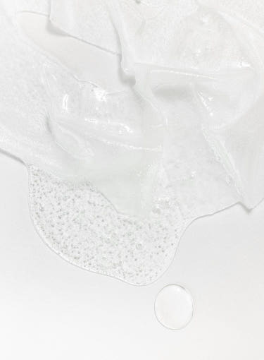 Close-up of Beauty of Joseon Centella Asiatica Calming Mask sheet with essence droplets on white background.
